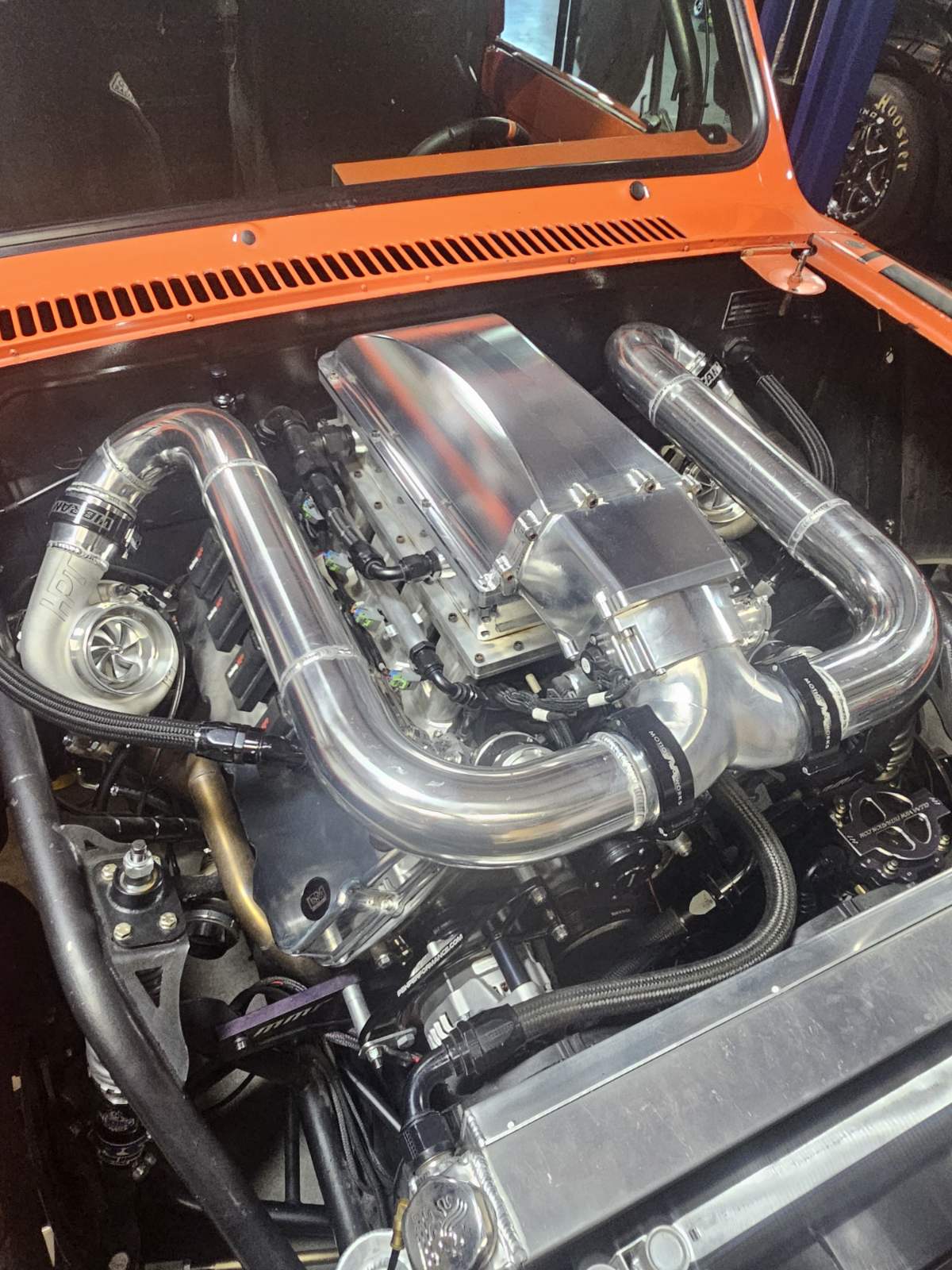 1976 Scout engine bay - massive twin-turbo V8 with polished aluminum and chrome exhaust